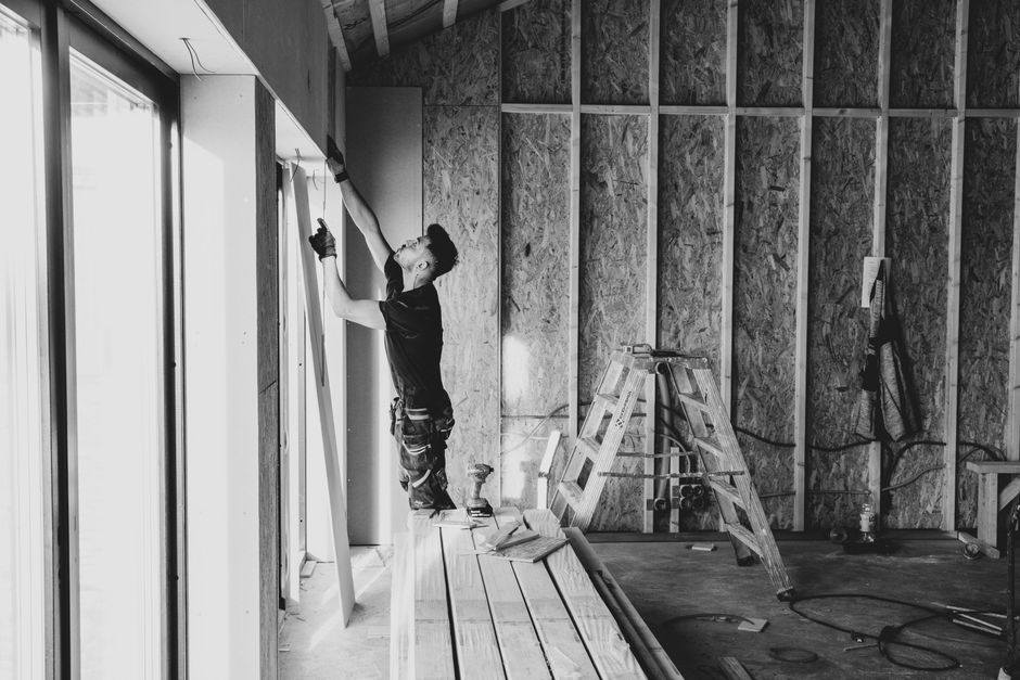 Professional contractor installing a vinyl window